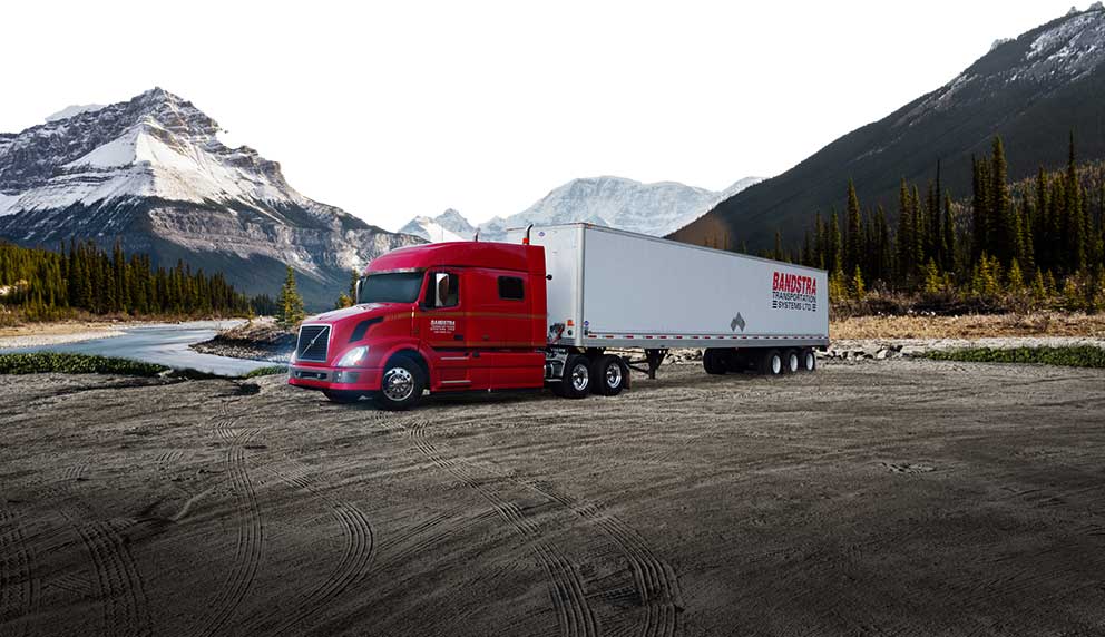 Bandstra highway truck parked in front of British Columbia forest and mountains 