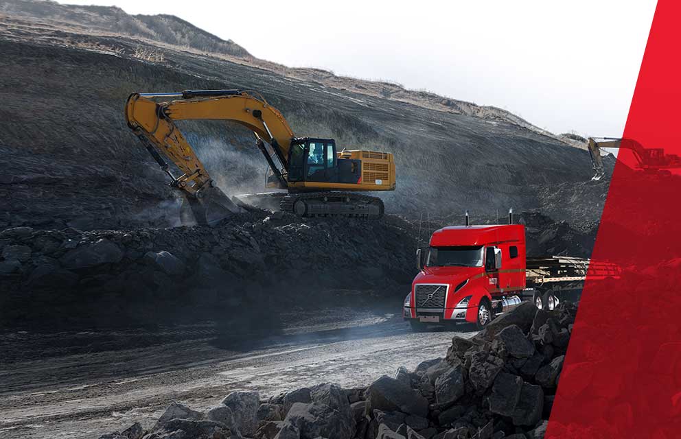 Bandstra red flat deck truck driving through mining site  