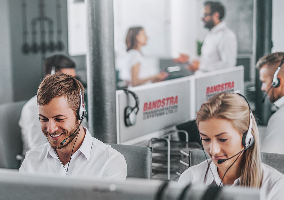 Bandstra employees in office wearing phone headsets