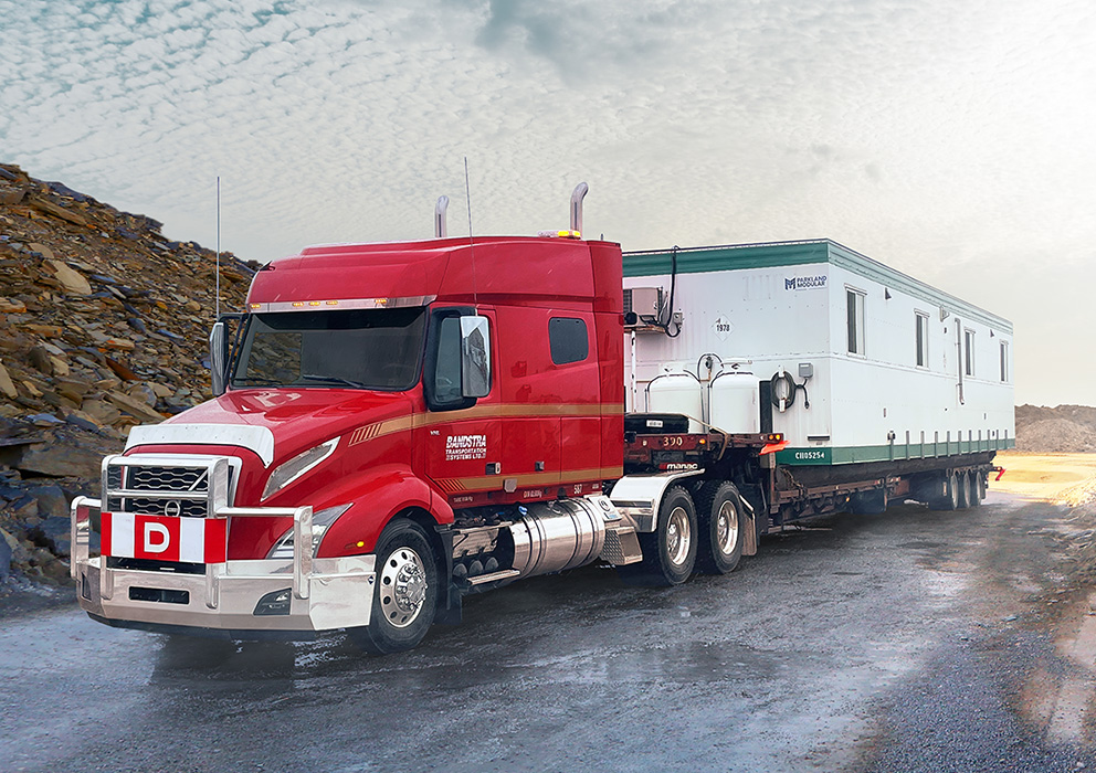 Bandstra heavy haul truck carrying portable housing unit