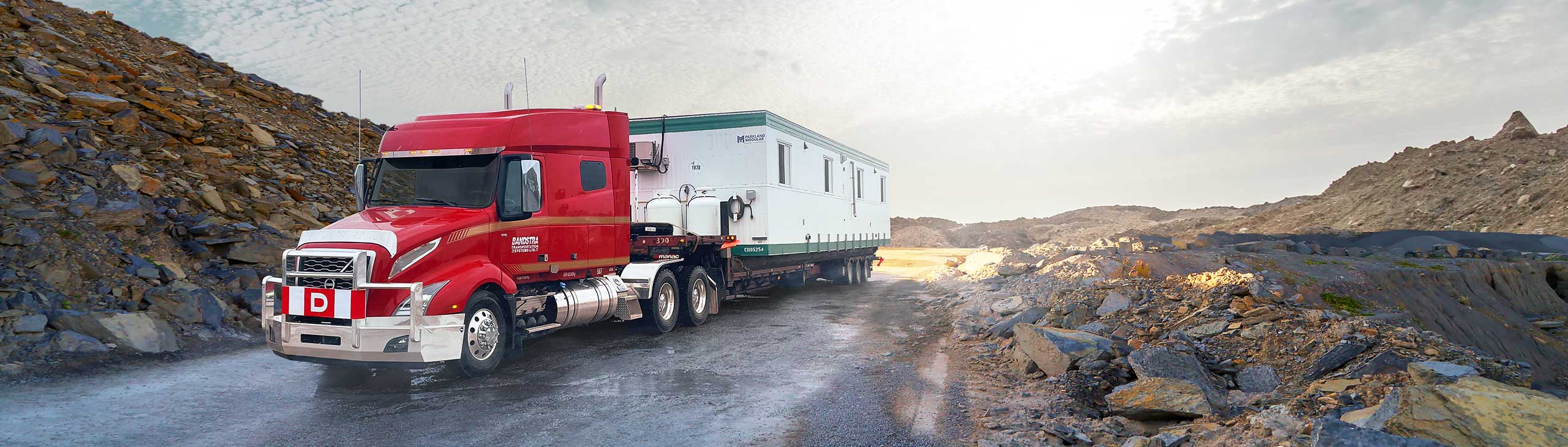 Bandstra heavy haul truck carrying portable housing unit