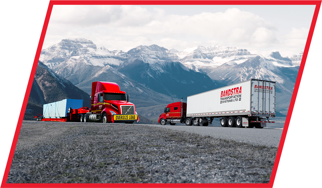 Bandstra heavy haul truck with oversized load and Bandstra tractor trailer driving in opposite directions on BC highway   