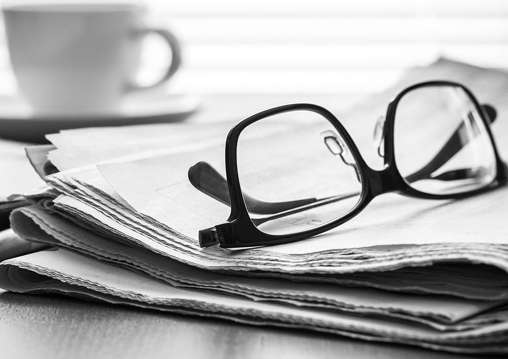 Glasses placed on top of newspaper