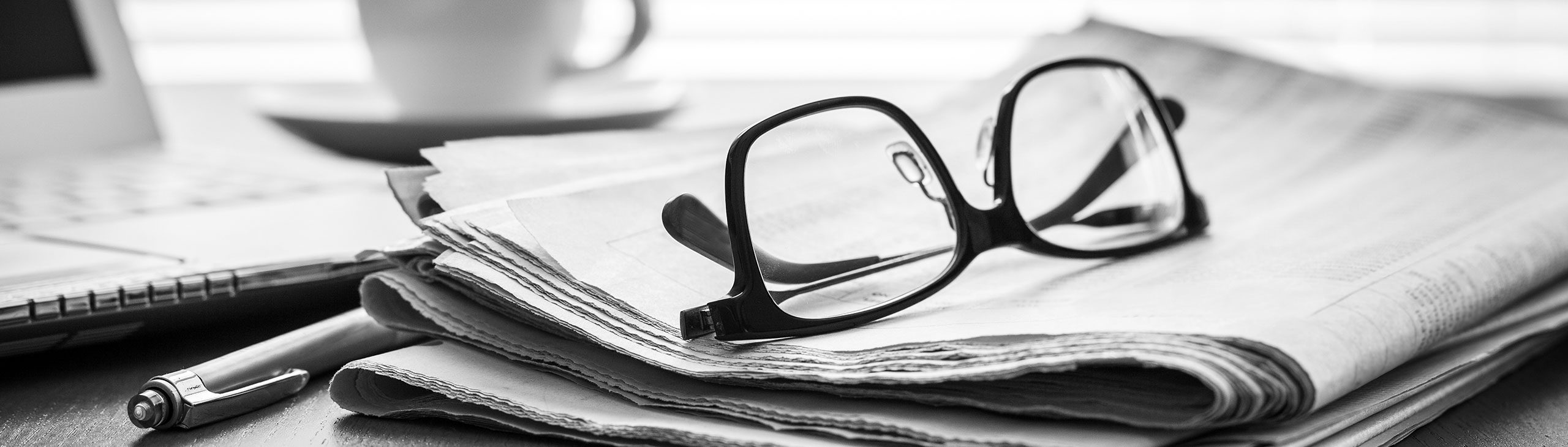 Glasses placed on top of newspaper