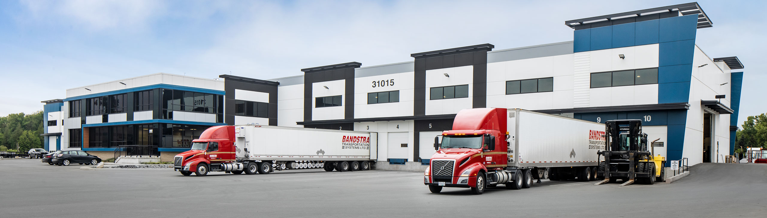 Bandstra trucks backed into cross docking stations at terminal